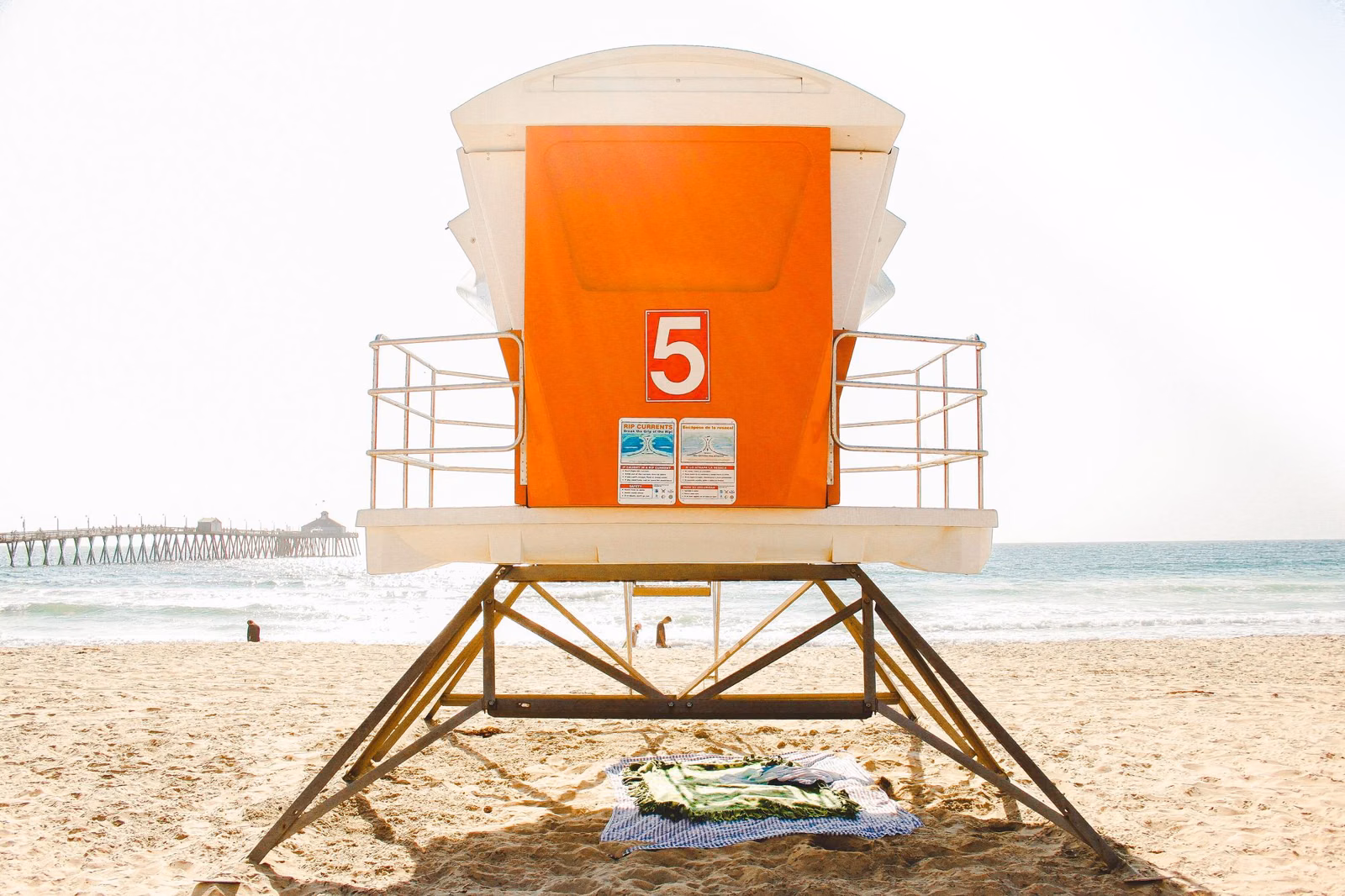 A lifeguard tower on the sand of a Southern California state beach on a bright day
